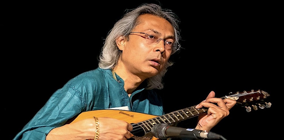 A picture of Sugato Bhaduri playing Mandolin.