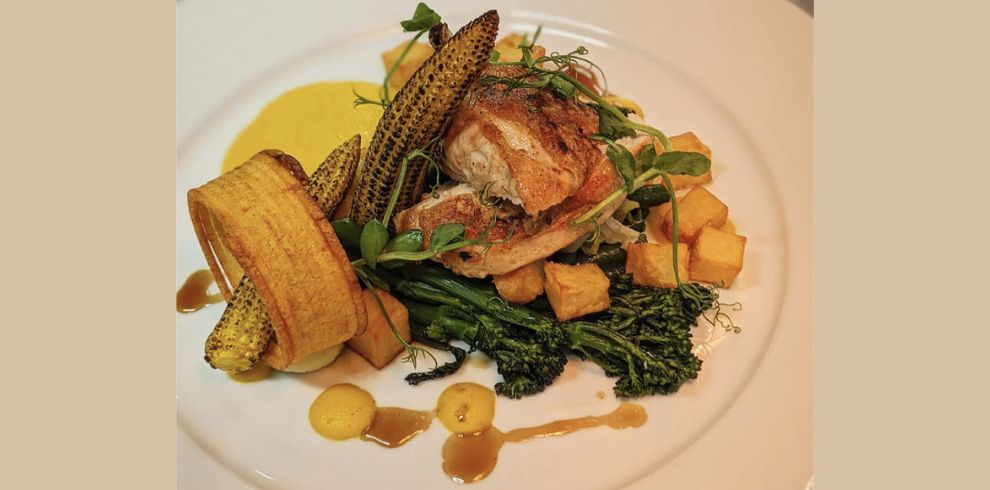 An image of Roast chicken supreme parmentier potato torched baby corn and purée chicken jus.