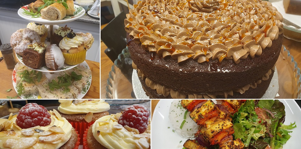 Four pictures of produce from the cafe Vegan Earth. The first picture shows an afternoon tea with a selection off sandwiches and sweet treats, the second image shows a chocolate cake, the third shows three cupcakes with icing and a raspberry, the fourth image shows vegan kebabs.