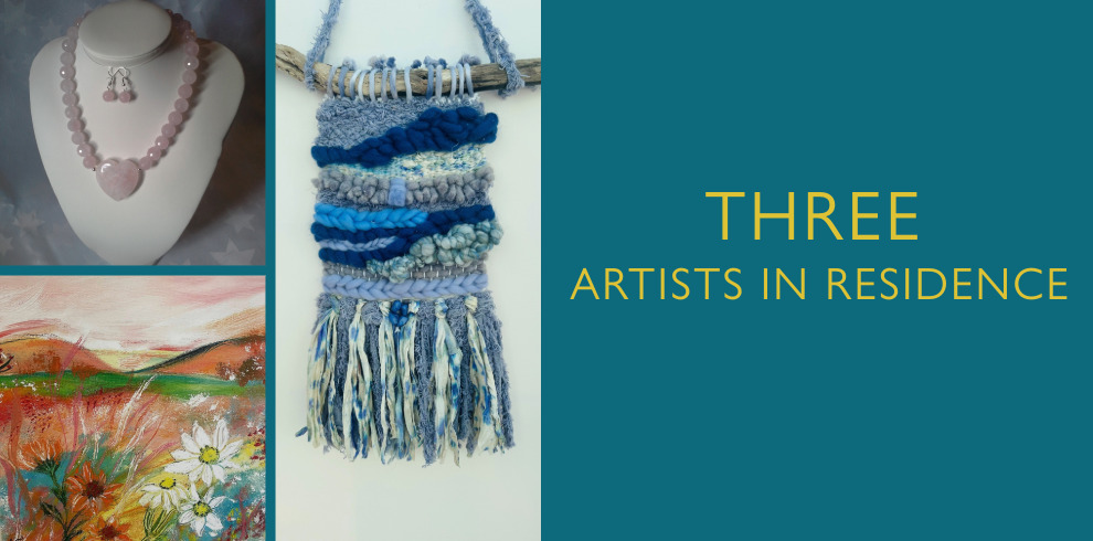 A promotional graphic titled "Three Artists in Residence" features three distinct artworks. On the left, a beaded pink necklace with a heart-shaped pendant and matching earrings is displayed on a white bust. Below it is a colorful painting of a vibrant landscape with wildflowers and rolling hills in warm tones. In the center is a woven textile wall hanging in shades of blue, white, and grey, featuring various textures and fringes, hanging from a piece of driftwood. The right side of the image has a teal background with yellow text that reads "THREE ARTISTS IN RESIDENCE."