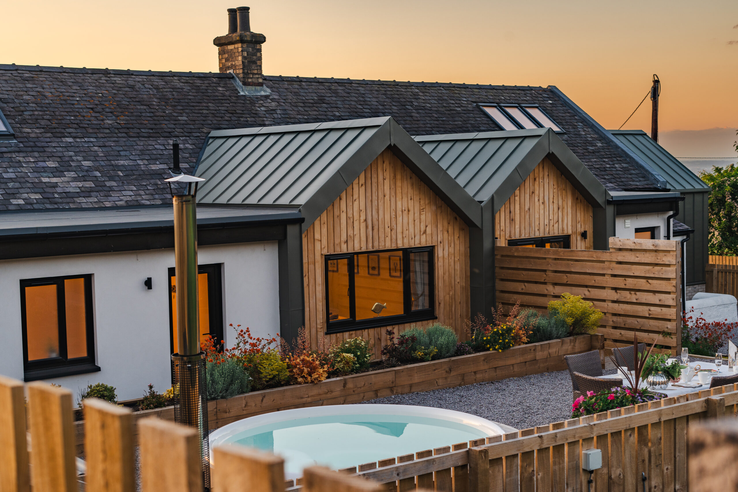 An image of a cottage at sunset.