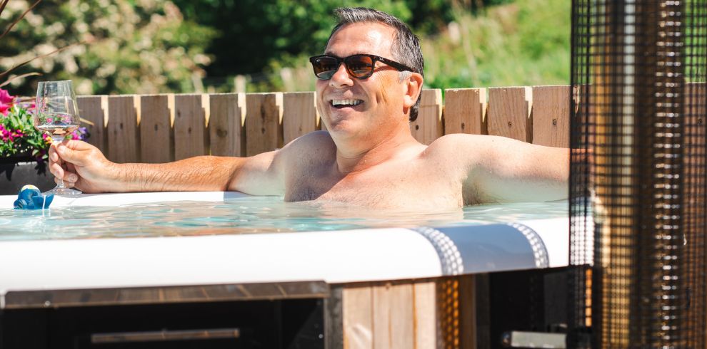A man smiling in a hot tub.
