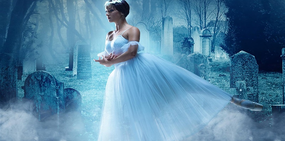A person in a white ballet dress performing a dance move in a foggy graveyard. The background features tombstones and leafless trees, creating a ghostly, eerie atmosphere. The dancer's face is obscured for privacy.