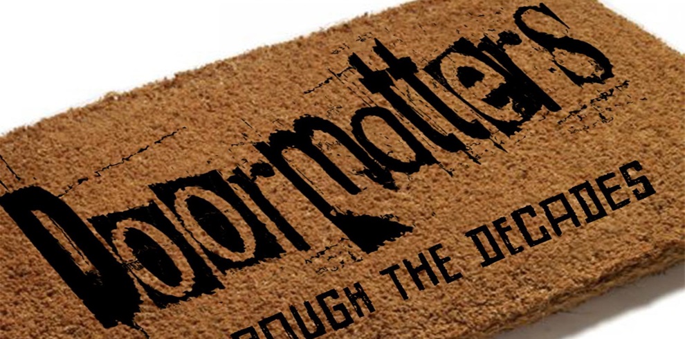 A doormat with the text 'Dolor matters THROUGH THE DECADES' written on it. The text is stylized with a distressed, grunge-like font.