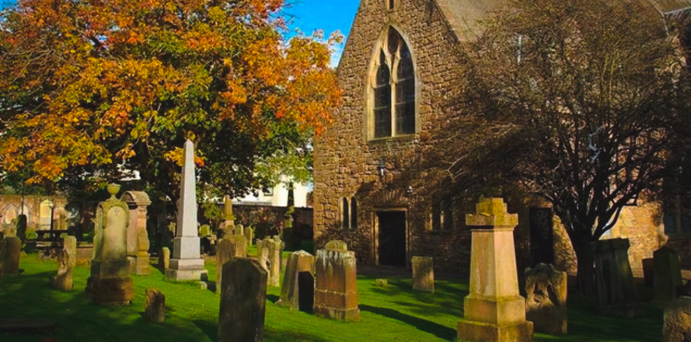 Photograph of a church and grave yard.