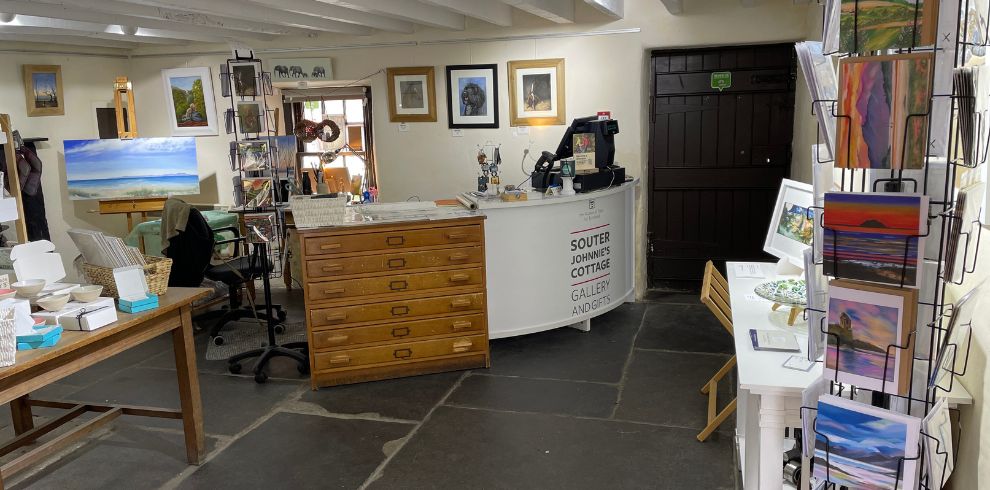 Interior of a small art gallery and gift shop.