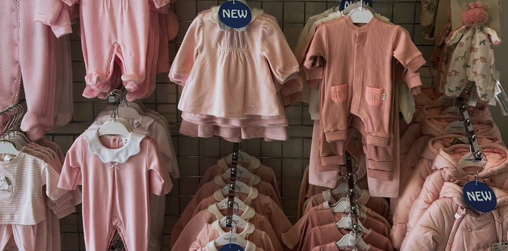 Images of children's clothes hanging on a rail.