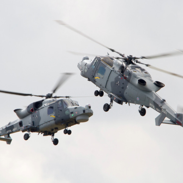 Two helicopters flying close together.