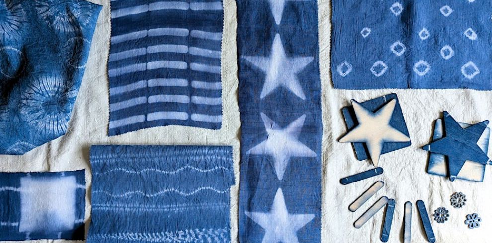 An image of tye dye pieces of material laid out on a table.