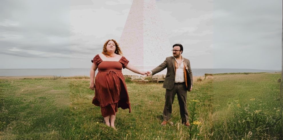An image of a man and woman holding hands outdoors. Photo Credit: Mark Brimacombe