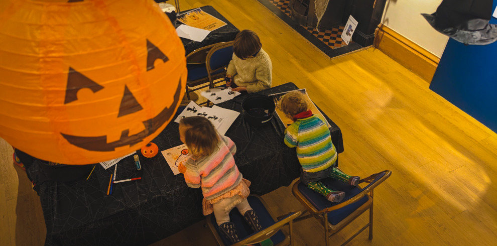 Children colouring in at a table