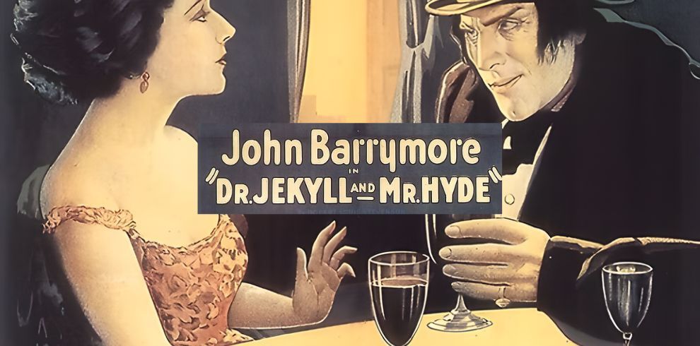 A vintage movie poster showing a woman in a red dress sitting at a table with a sinister-looking man in dark clothing and a hat. The man stares intensely at her while holding a drink. The text in the center reads: “John Barrymore in ‘Dr. Jekyll and Mr. Hyde.’”