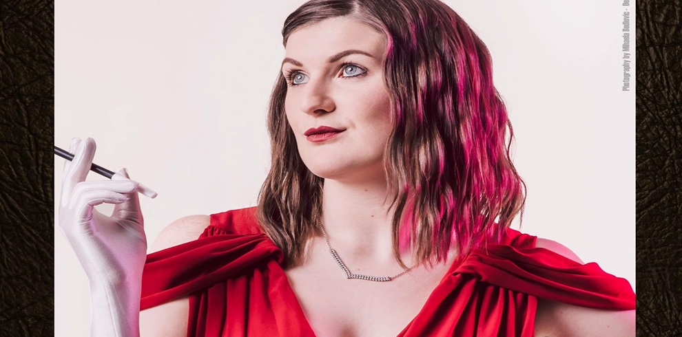 A picture of a female character from the Can You Catch The Killer production. She is wearing a red dress.