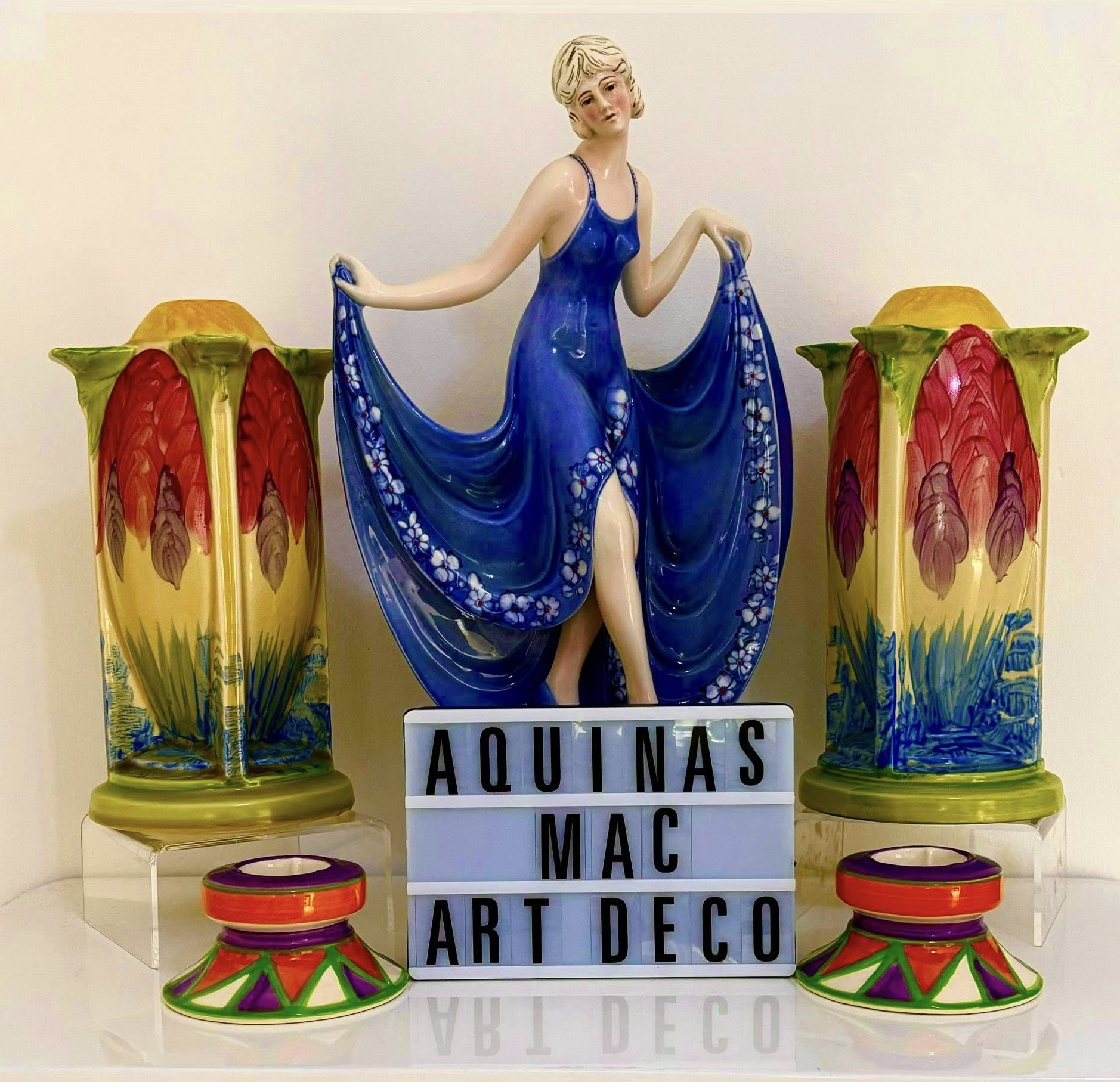 An image of art deco figurine, vases and candlesticks.