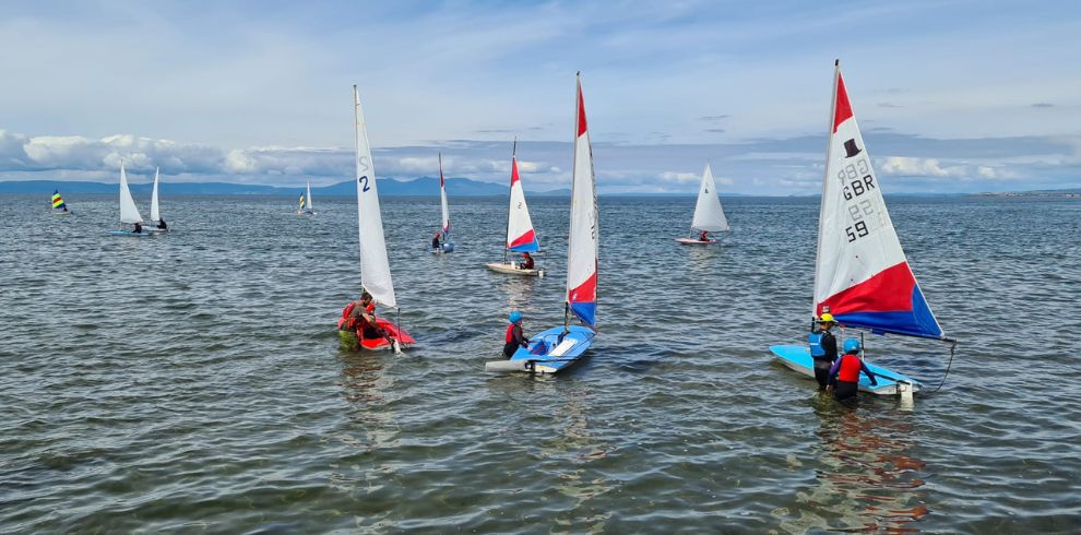 People in the sea learning how to sail.