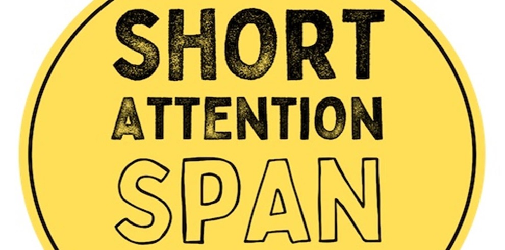 A circular yellow badge with bold black text that reads "SHORT ATTENTION SPAN." The words are stacked vertically, with "SHORT" at the top, "ATTENTION" in the middle, and "SPAN" at the bottom. The design uses a mix of solid and outlined fonts to emphasize the message, giving it a playful and slightly ironic tone. The overall style suggests a humorous take on modern-day focus challenges.