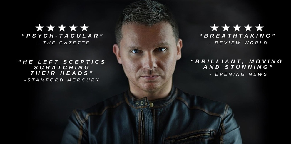 Promotional graphic featuring a person wearing a black leather jacket against a dark background. Surrounding the figure are four review quotes with star ratings: Left top: “★★★★★ ‘PSYCH-TACULAR’ – The Gazette” Left bottom: “‘He left sceptics scratching their heads’ – Stamford Mercury” Right top: “★★★★★ ‘BREATHTAKING’ – Review World” Right bottom: “‘Brilliant, moving and stunning’ – Evening News.”