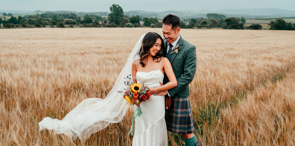 Newly married couple in a corn field.
