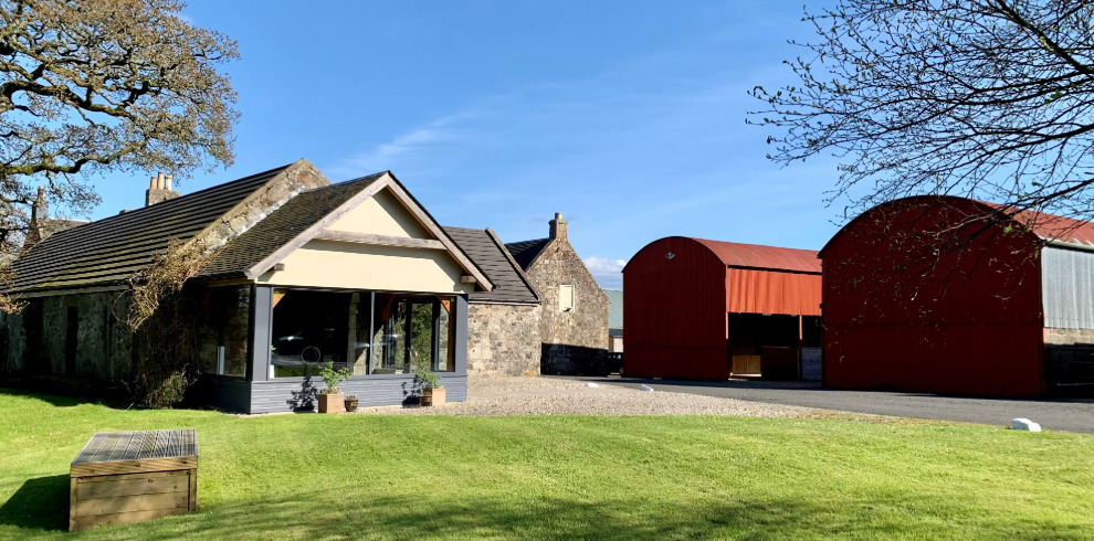 Exterior of modern and rustic red barns.