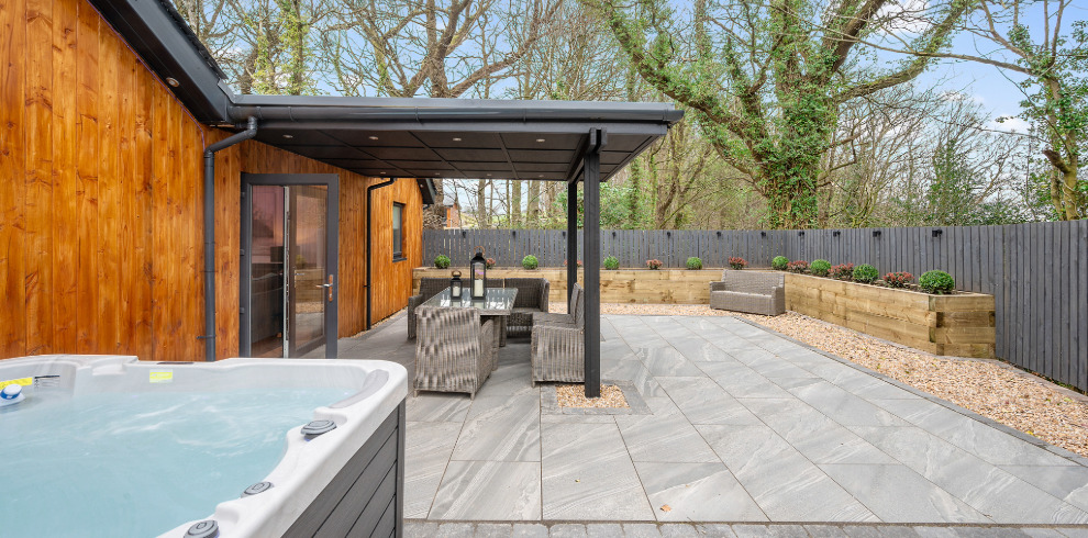 Hot tub in outside wooded setting.