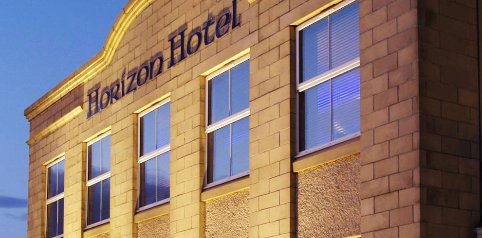Horizon Hotel 1 Horizon Hotel facade at night.