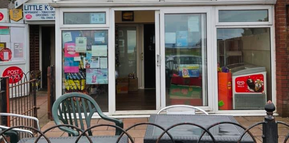 Exterior of shop front with patio seating.
