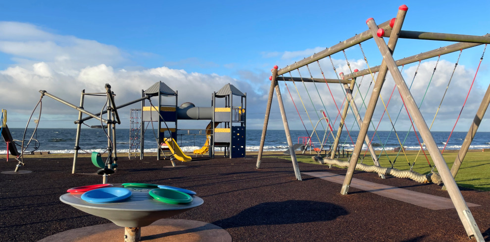 Outdoor play equipment at play park beside the beach.