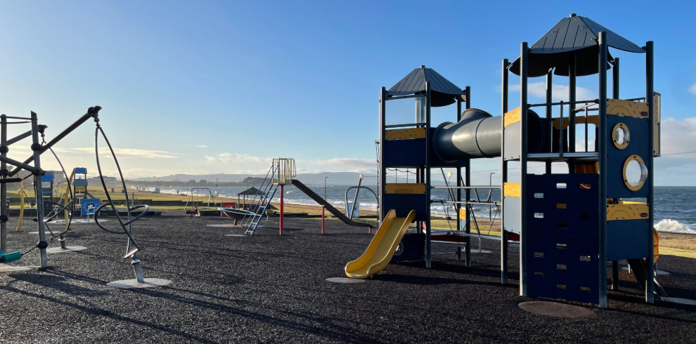 Outdoor play equipment at play park beside the beach.