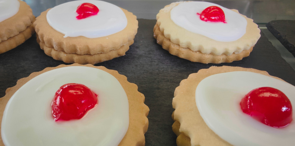 Freshly baked empire biscuits on a tray.