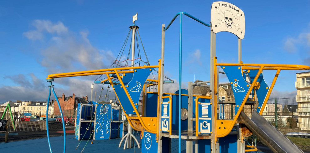 Outdoor blue and yellow pirate ship play equipment.