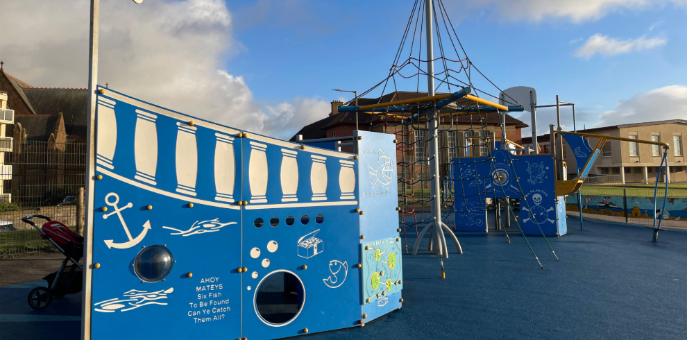 Outdoor blue pirate ship play equipment.