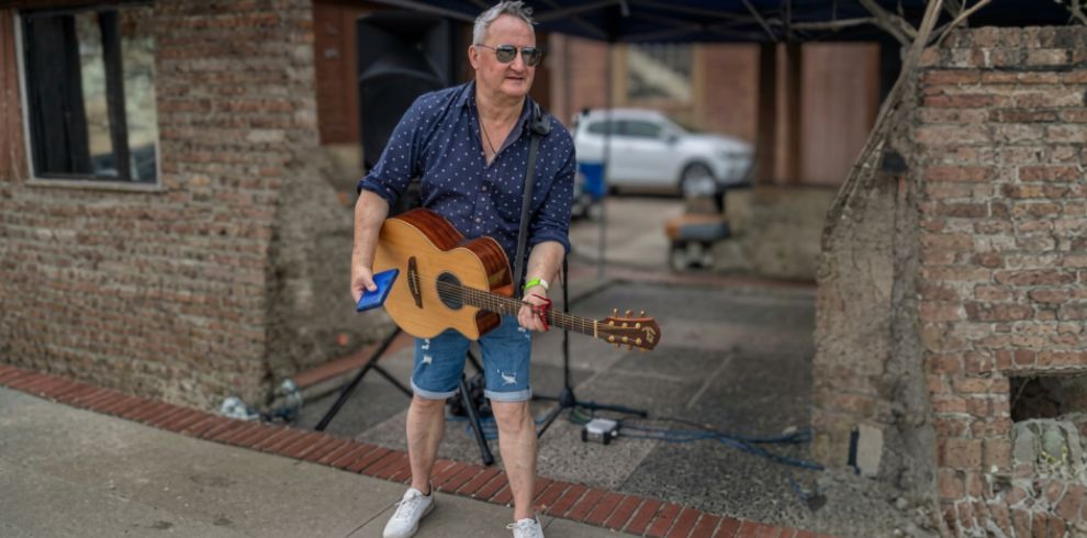 A man holding a guitar.