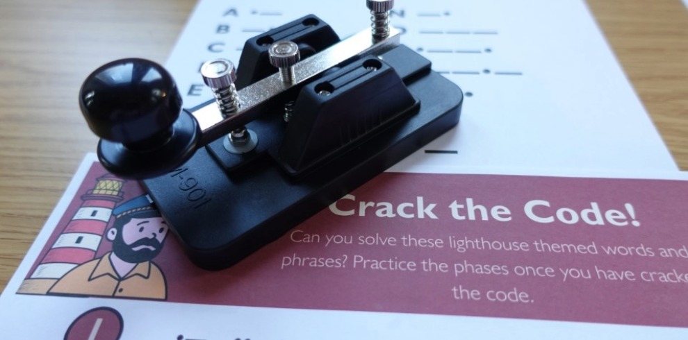 Morse code device on top of a paper worksheet.