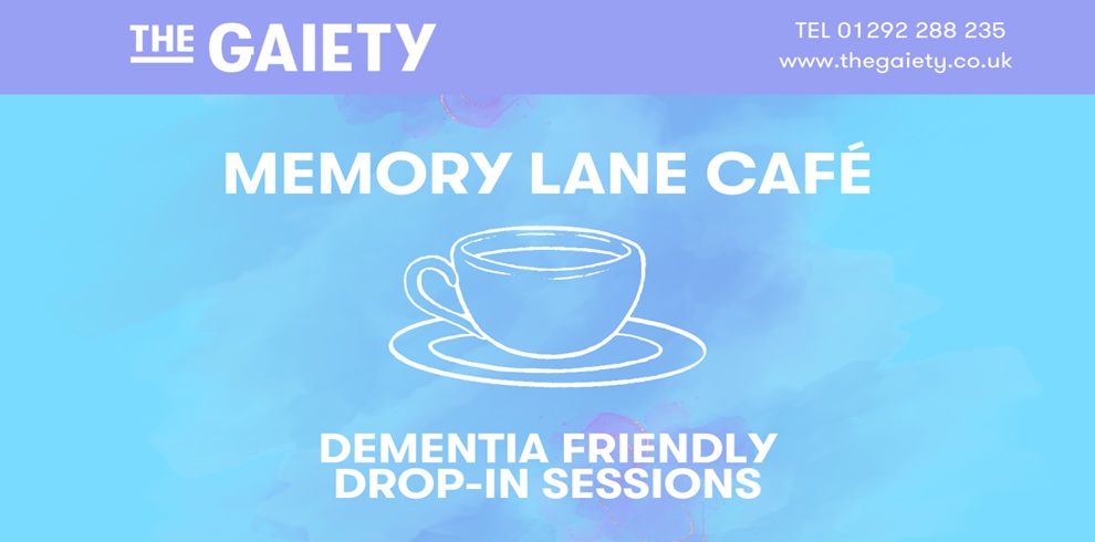 Graphic for The Gaiety’s Memory Lane Café, featuring a simple line drawing of a teacup on a soft blue watercolor background. Text promotes dementia‑friendly drop‑in sessions, with contact details for The Gaiety at the top.