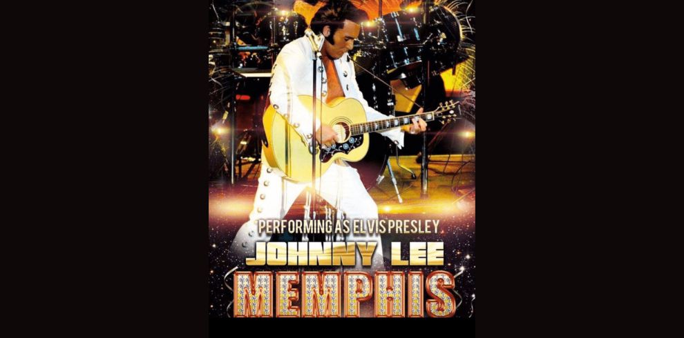 Elvis Presley impersonator playing a guitar on stage.