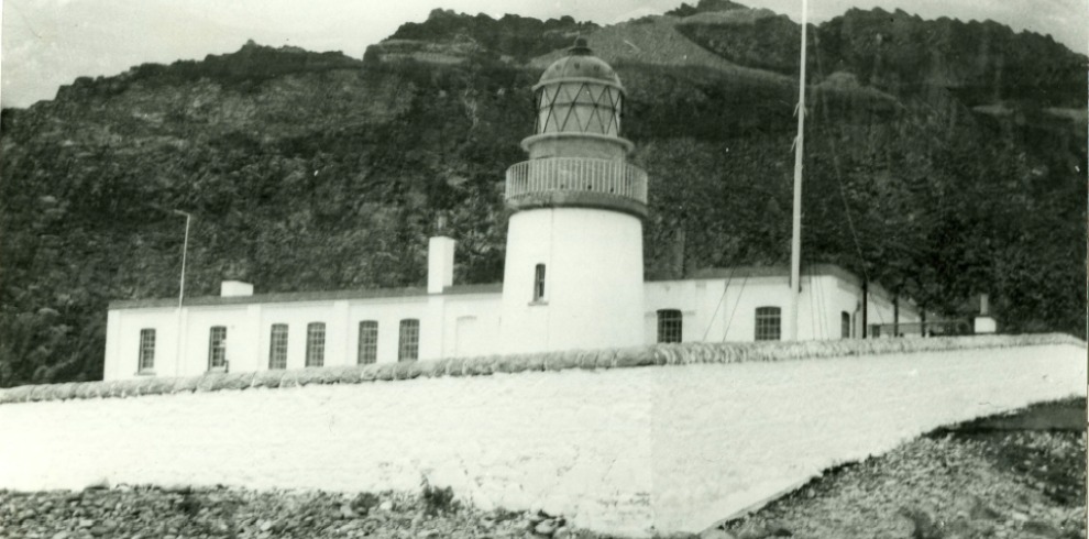 Black and White image of a lighthouse on an island.