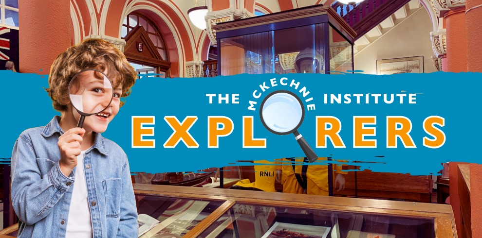 A promotional image for “The McKechnie Institute Explorers,” featuring a child in a denim jacket standing in front of a colourful banner with the programme’s name and a magnifying glass graphic. Behind the banner is the interior of a museum, with display cases, architectural details, and framed items visible.