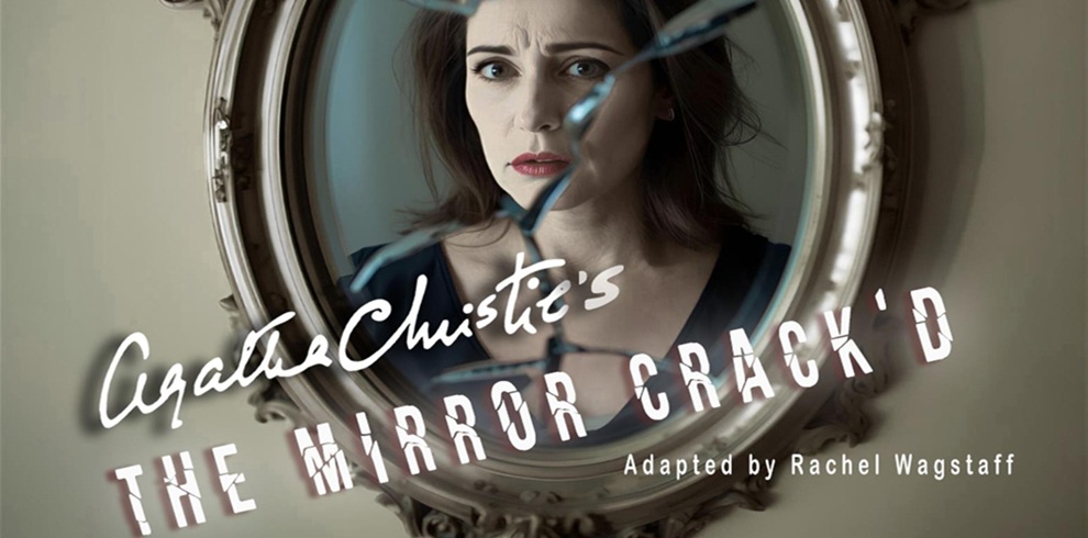 Promotional image for Agatha Christie’s The Mirror Crack’d, showing a cracked, ornate oval mirror reflecting the upper body of a person in a dark top. The title appears in stylised white lettering across the lower half of the image, with the credit ‘Adapted by Rachel Wagstaff’ beneath it.