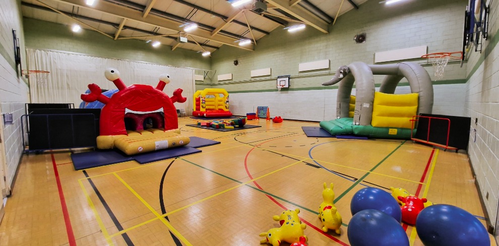 Inflatable play equipment in a gym area.