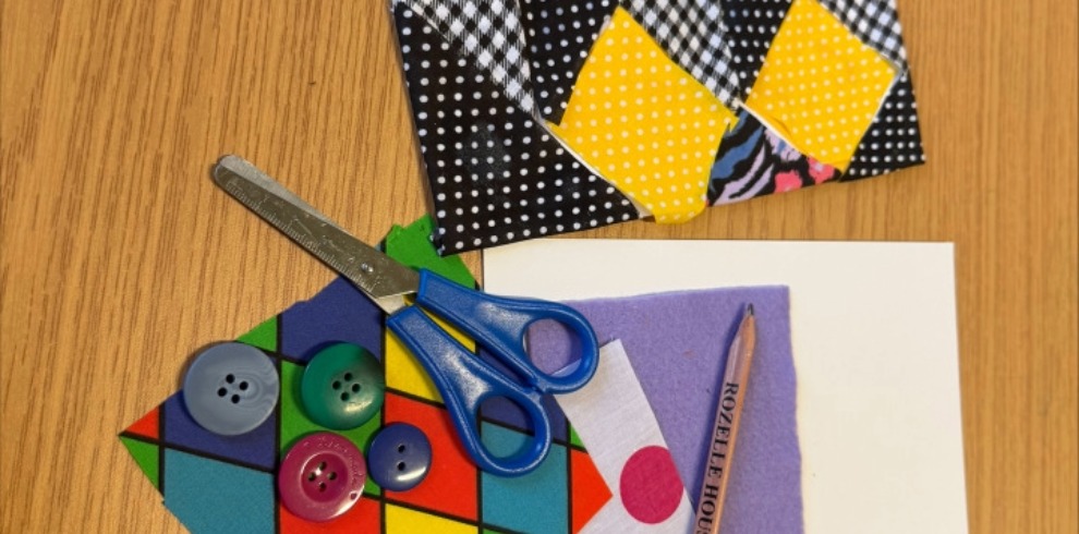 An image of scissors, buttons and material.