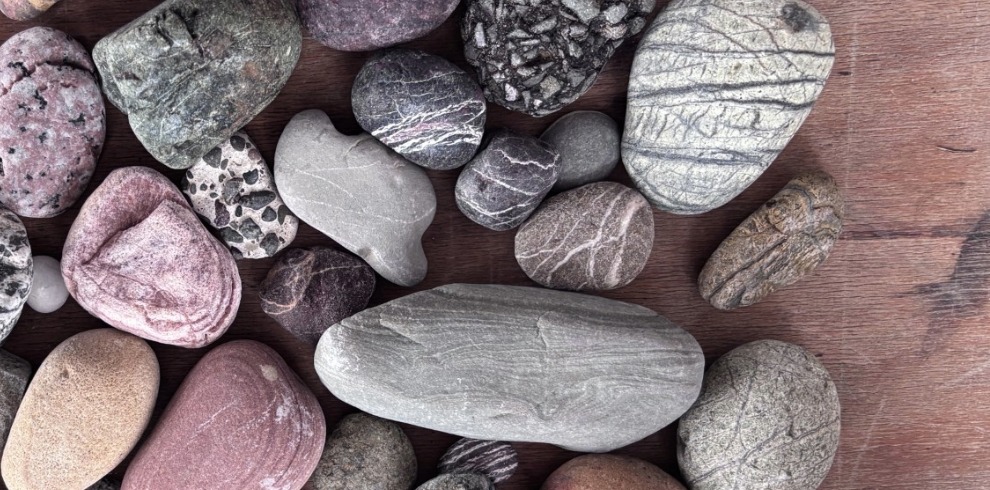 A selection of beach stones on a table.