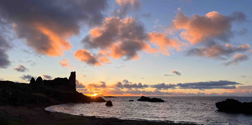 Sunset and castle next to the sea.