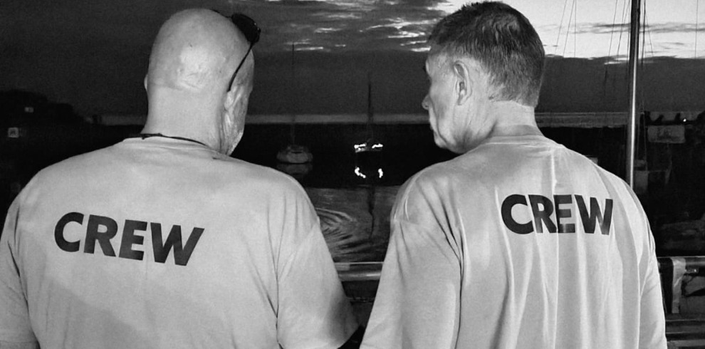 Two men facing with their backs to the camera.