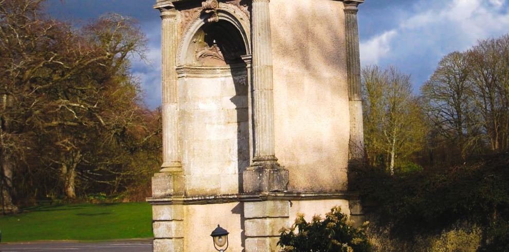 Stone archway in parkland.