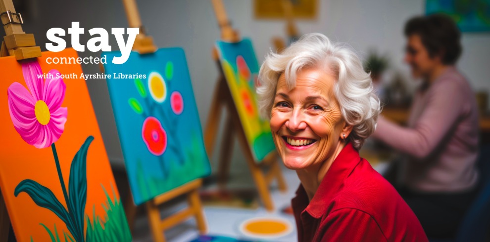 Promotional image showing an art class room with small canvases on wooden easels painted with bright flowers; in the foreground, a seated person with short grey hair faces the camera, while another person paints in the background. White text on the left reads “stay connected with South Ayrshire Libraries.”