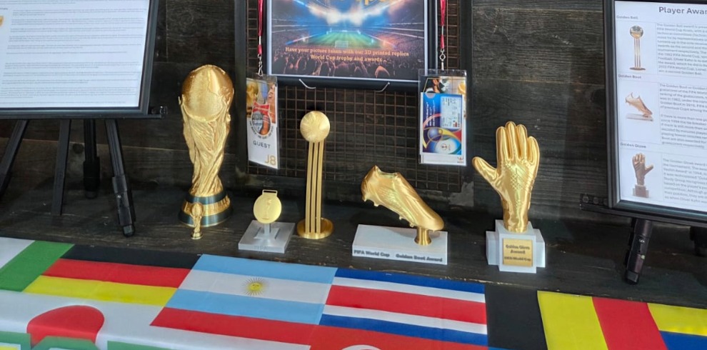 Golden 3D printed football trophies.