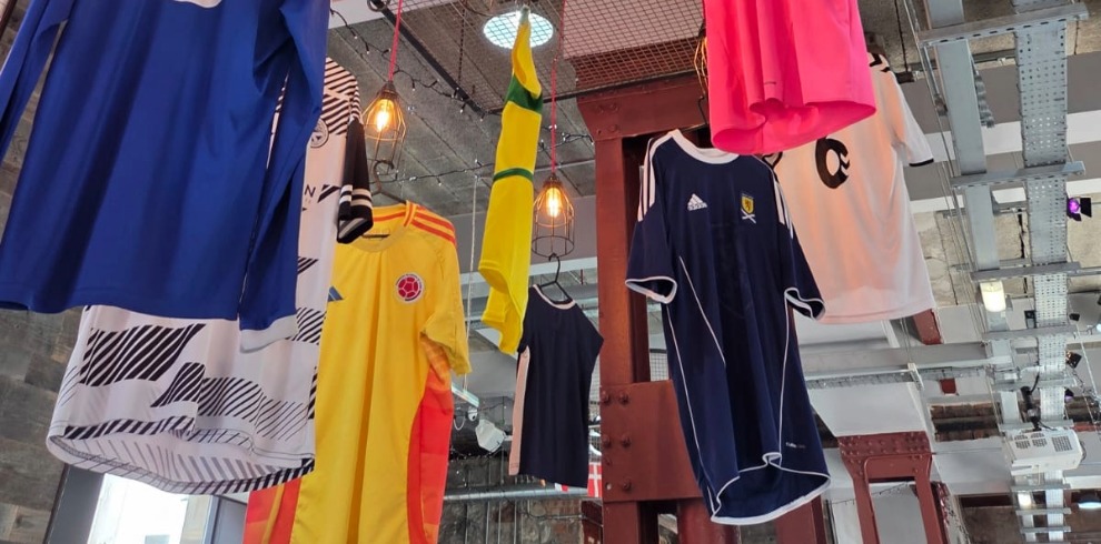 Football shirts hanging display from a ceiling.