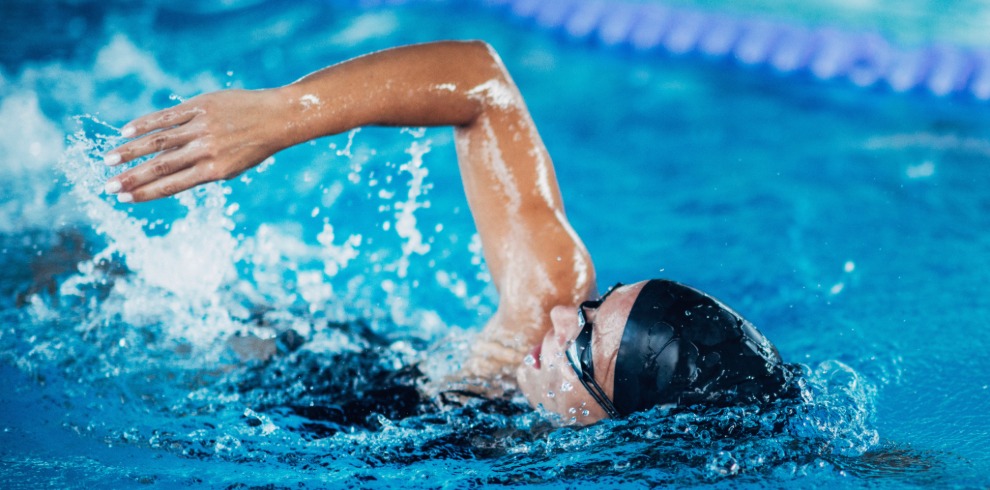 Person doing lengths in a swimming pool.