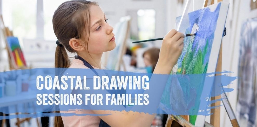 Promotional image for a family art activity. A young person sits at an easel painting a colourful coastal-themed picture in an art studio, holding a paintbrush close to the canvas. Other easels and art materials are visible in the softly blurred background. Across the lower part of the image, a blue brushstroke graphic contains the text: “COASTAL DRAWING SESSIONS FOR FAMILIES.” The image uses bright natural lighting and shades of blue, green and white that reflect a coastal theme.