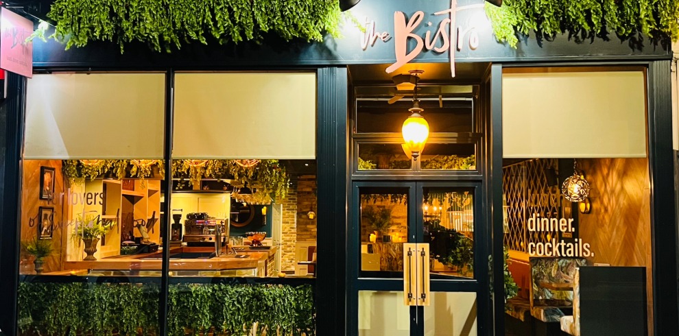 The Bistro Ayr 2 Exterior of a restaurant with warm lights shining through the windows.